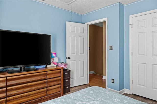 bedroom with wood-type flooring and a textured ceiling