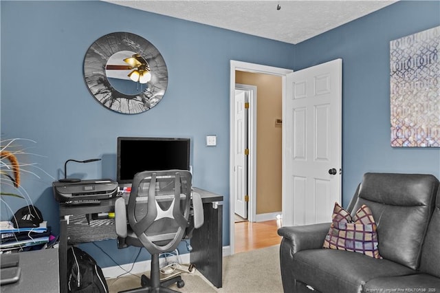 office with carpet and a textured ceiling