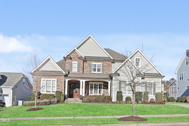 craftsman-style home featuring a front lawn