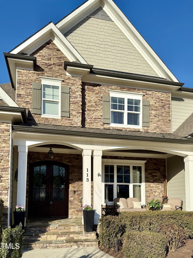 property entrance featuring a porch and french doors