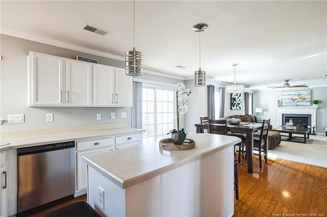 kitchen with white cabinets, hanging light fixtures, and dishwasher