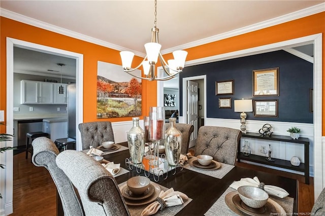 dining space with ornamental molding, dark hardwood / wood-style floors, and a chandelier