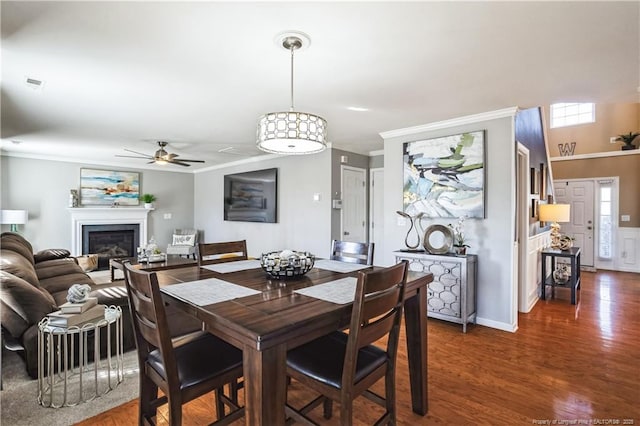 dining area featuring ornamental molding, dark hardwood / wood-style floors, and ceiling fan