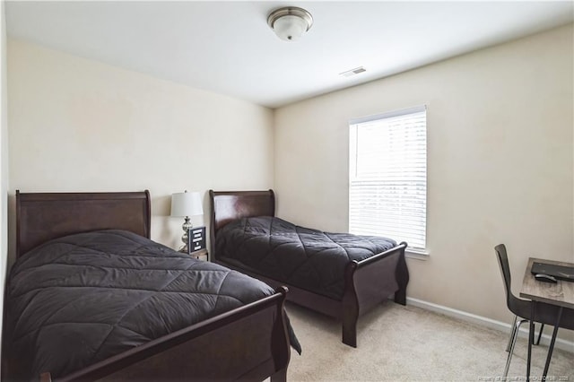 bedroom with light colored carpet