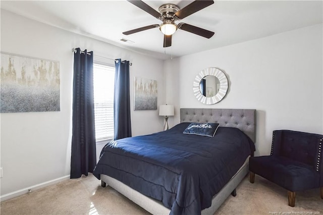 bedroom featuring ceiling fan and light carpet