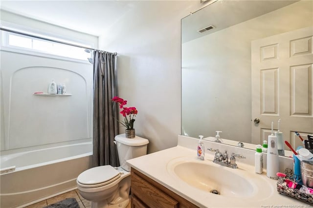 full bathroom featuring vanity, shower / tub combo with curtain, tile patterned floors, and toilet