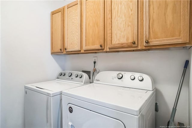 laundry room with cabinets and washing machine and clothes dryer