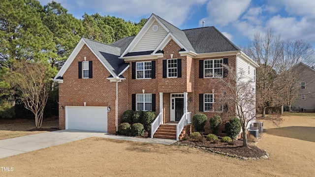 view of front of house featuring a garage and cooling unit