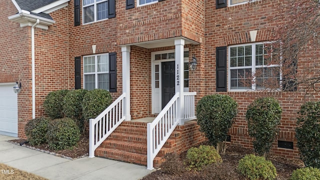 doorway to property with a garage