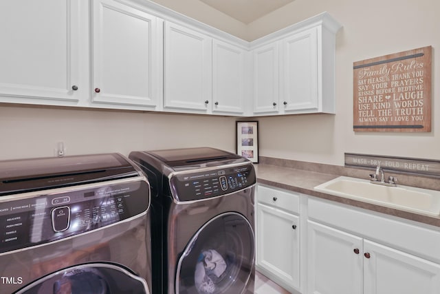 laundry area with cabinets, sink, and washer and clothes dryer