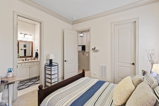 tiled bedroom with crown molding, ensuite bath, and sink