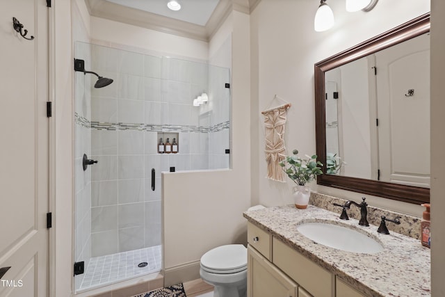 bathroom featuring vanity, a shower with door, and toilet