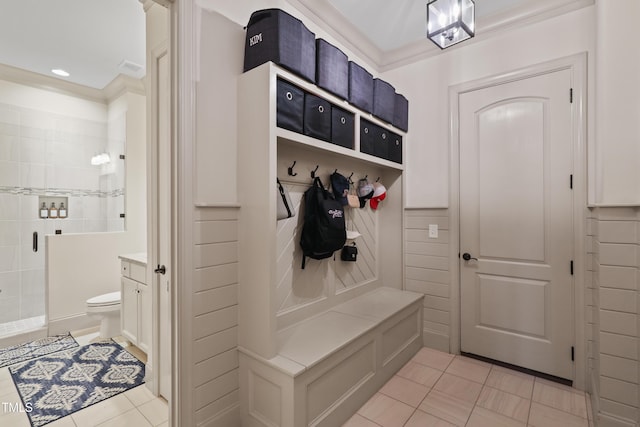 mudroom featuring light tile patterned flooring and ornamental molding