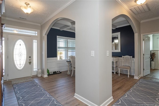 foyer featuring beam ceiling, crown molding, coffered ceiling, and dark hardwood / wood-style flooring