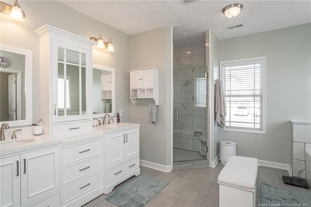 bathroom featuring tile patterned flooring, vanity, and an enclosed shower