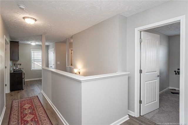 hall featuring hardwood / wood-style flooring and a textured ceiling