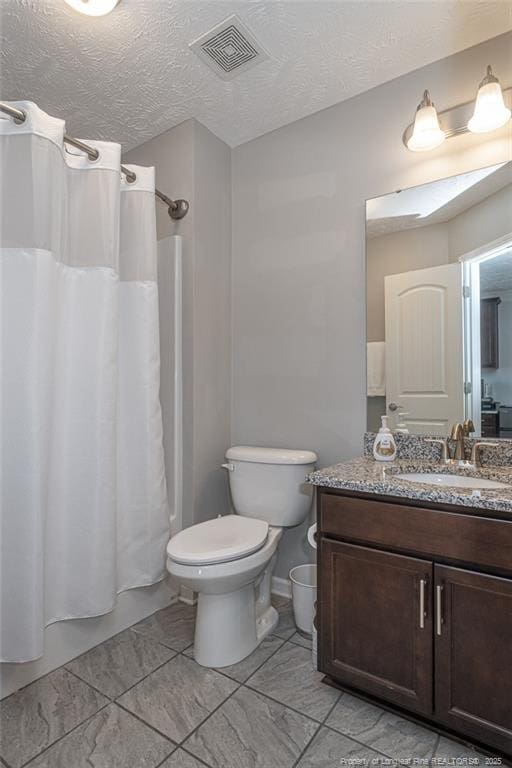 full bathroom with vanity, toilet, a textured ceiling, and shower / bath combo