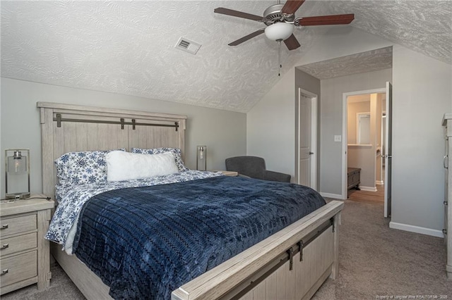 bedroom featuring vaulted ceiling, light carpet, ceiling fan, and a textured ceiling