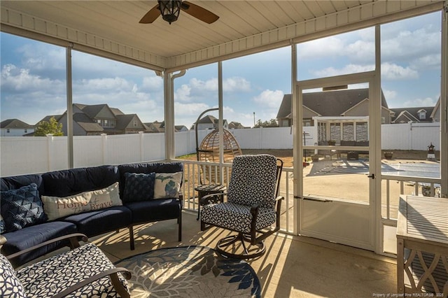 sunroom / solarium featuring ceiling fan