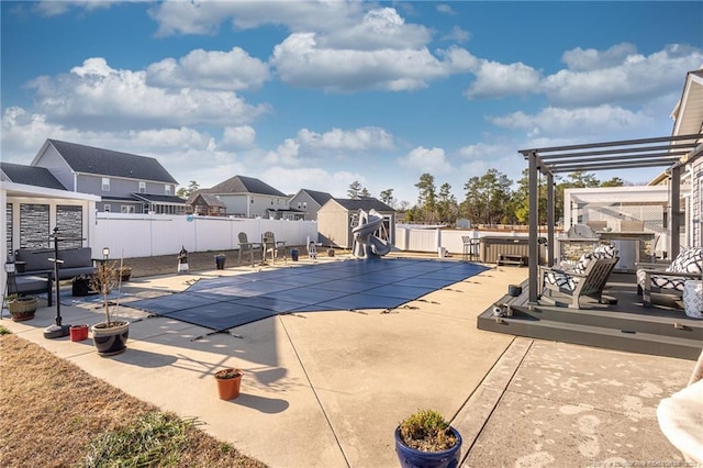 view of pool featuring a pergola, a patio area, a deck, and a water slide