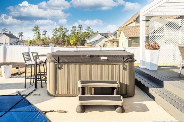 deck with a hot tub and a patio area