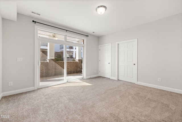 unfurnished bedroom featuring baseboards, carpet flooring, visible vents, and access to exterior