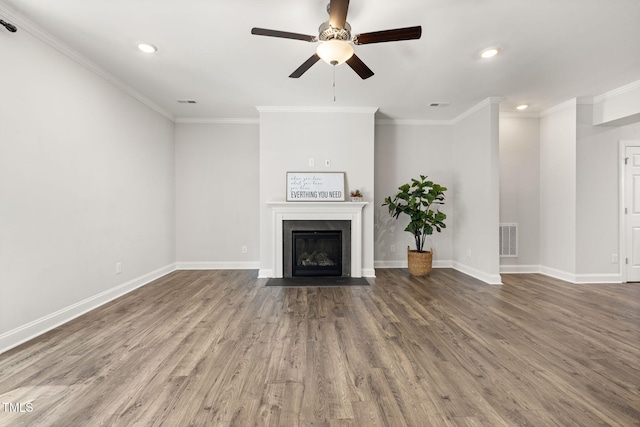 unfurnished living room with a fireplace with flush hearth, visible vents, crown molding, and wood finished floors