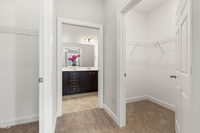 spacious closet featuring light carpet