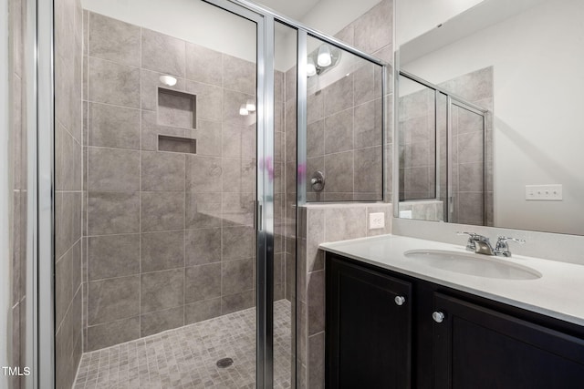 full bathroom featuring a stall shower and vanity