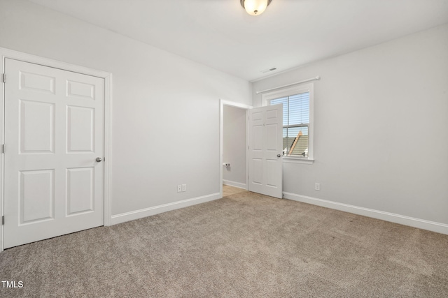 unfurnished bedroom featuring carpet and baseboards