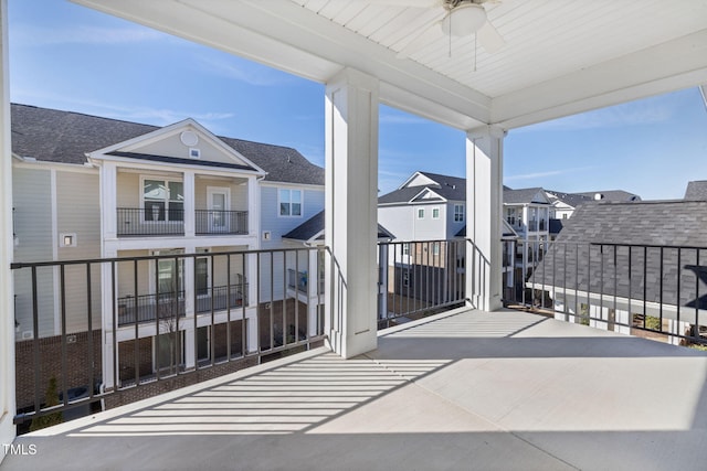 balcony with a residential view and a ceiling fan