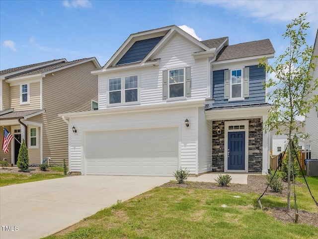 view of front of home featuring an attached garage, concrete driveway, stone siding, a standing seam roof, and a front yard