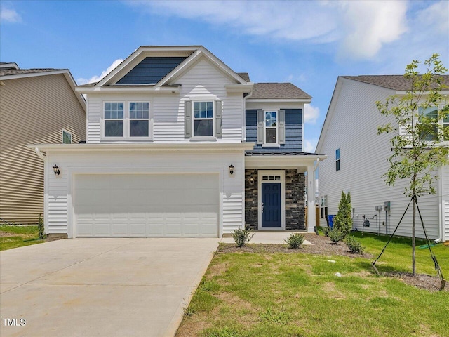 view of front of home with a front yard, an attached garage, stone siding, and driveway