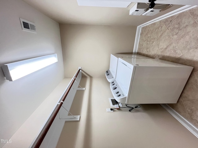 laundry room with stacked washer / dryer