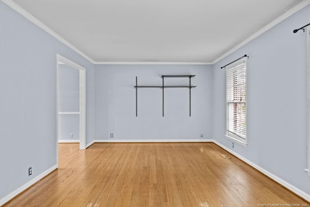 empty room featuring crown molding and light hardwood / wood-style floors