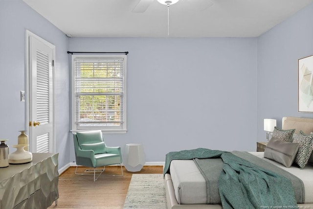 bedroom with hardwood / wood-style flooring and ceiling fan