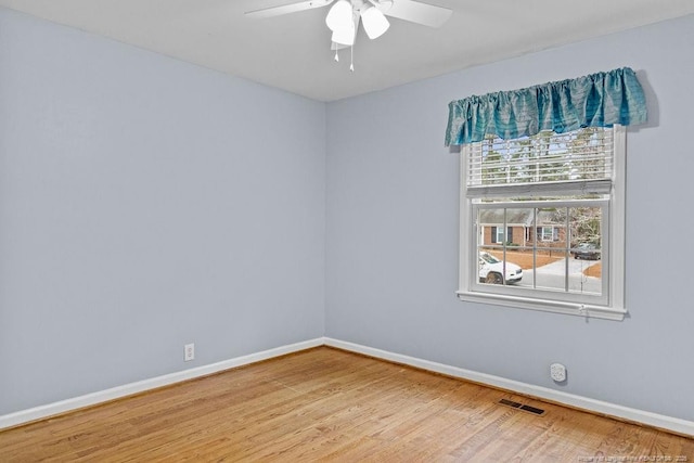 spare room with hardwood / wood-style flooring and ceiling fan