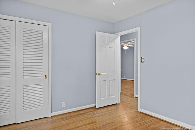 unfurnished bedroom featuring a closet and light hardwood / wood-style flooring