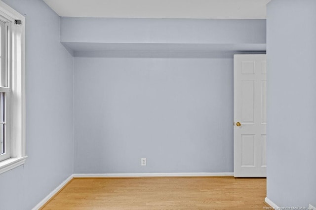 empty room featuring plenty of natural light and light hardwood / wood-style floors