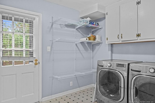 washroom featuring cabinets and separate washer and dryer