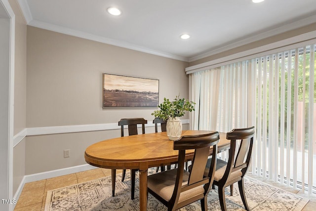 tiled dining area featuring crown molding