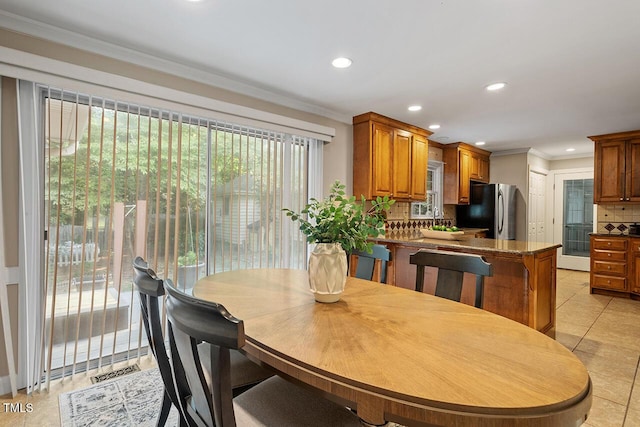 tiled dining room with ornamental molding