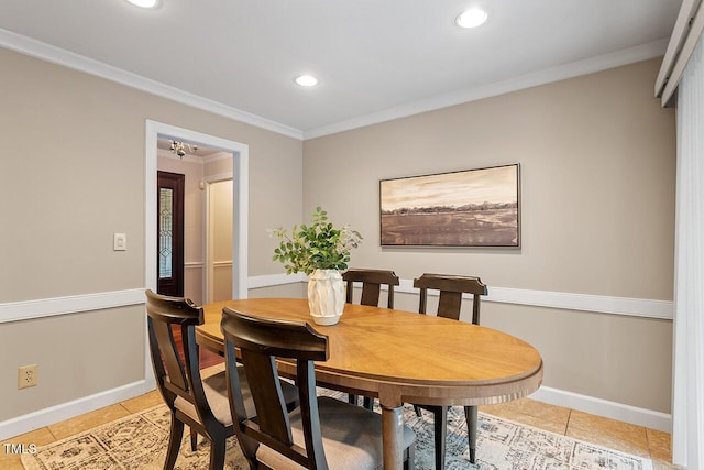 tiled dining space featuring ornamental molding