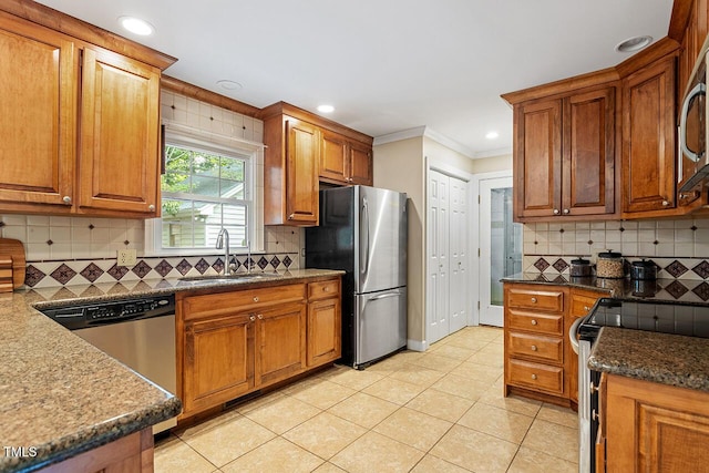 kitchen featuring sink, stainless steel appliances, tasteful backsplash, ornamental molding, and light tile patterned flooring