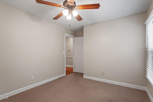 unfurnished bedroom featuring ceiling fan, carpet flooring, and a textured ceiling