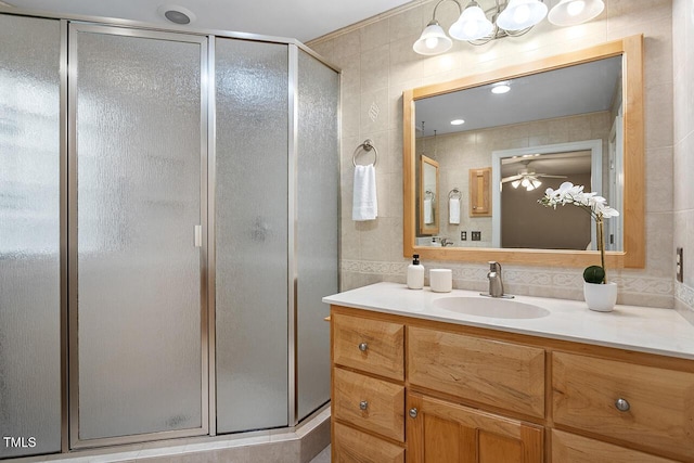 bathroom featuring vanity, tile walls, and an enclosed shower