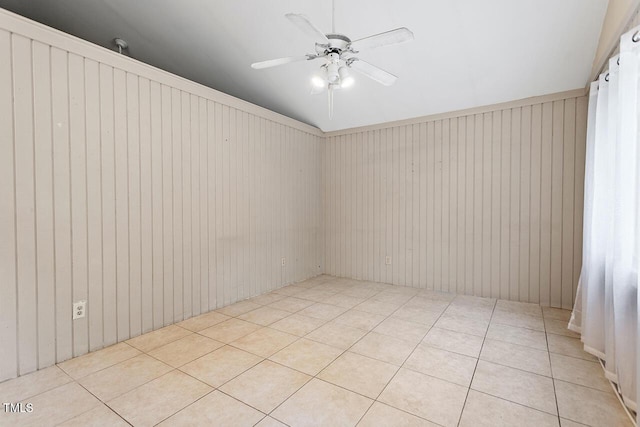 tiled spare room featuring ceiling fan