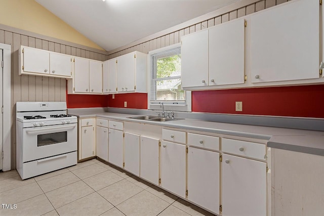 kitchen featuring white cabinetry, white gas range, lofted ceiling, and sink