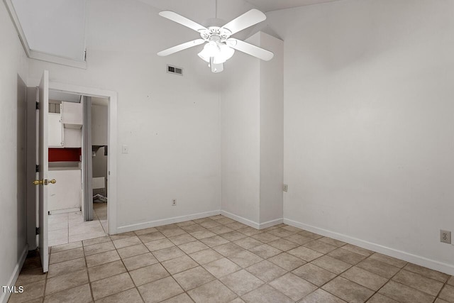 spare room with ceiling fan and light tile patterned floors