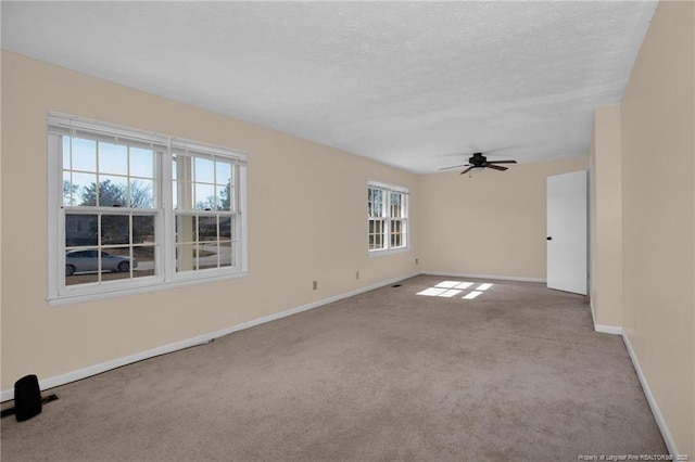 carpeted empty room featuring a textured ceiling and ceiling fan